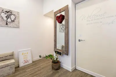 a hallway with a door with a mirror and a plant at Vaticano Charming Rooms in Rome