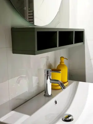 a bathroom sink with a mirror and a yellow container at DOMUS Villa Chigi in Rome