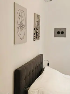 a bedroom with two pictures on the wall and a bed at DOMUS Villa Chigi in Rome