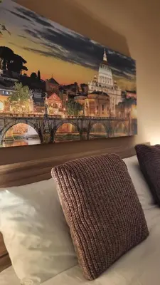a bedroom with a painting of a bridge at A casa di Tommy in Rome