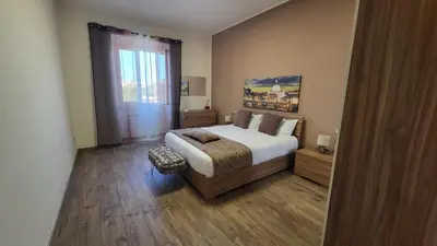 a bedroom with a large bed and a window at A casa di Tommy in Rome