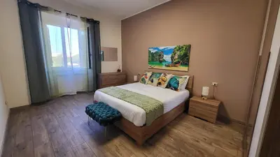 a bedroom with a bed and a large window at A casa di Tommy in Rome