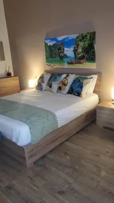 a bedroom with a large bed with pillows at A casa di Tommy in Rome