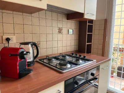 a kitchen with a stove with a tea kettle on it at Appiano Garden Apartment in Rome