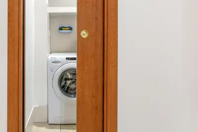 a laundry room with a washing machine in a room at 10 Minutes by Car from St Peter's Basilica in Rome
