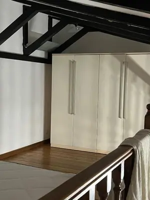 a kitchen with white cabinets and a wooden floor at EXCLUSIVE House OTTAVIANO in Rome