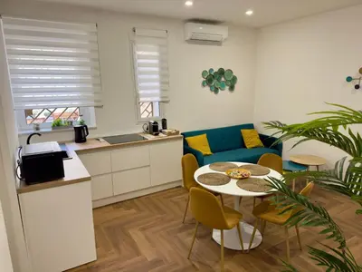 a kitchen and a living room with a table and chairs at Trastevere alla Lungaretta, Rome in Rome