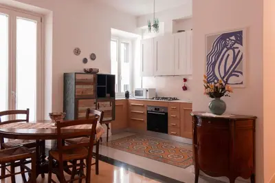 a kitchen with a table and a dining room at Appartamento Piazza Bologna - very well connected to Colosseum and station in Rome