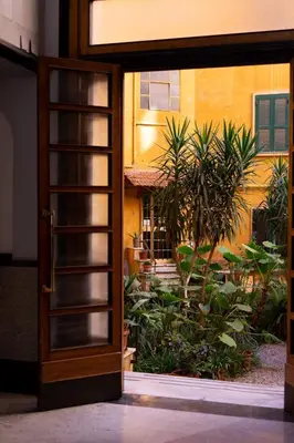 an open door leading to a garden outside a building at Appartamento Piazza Bologna - very well connected to Colosseum and station in Rome