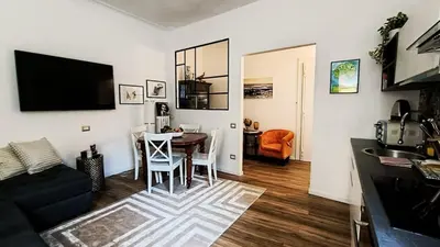 a living room with a table and a dining room at Verdastro Apartment in Rome