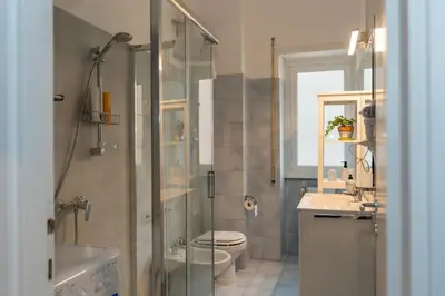 a bathroom with a shower and a toilet and a sink at La casa di Gegè Appio Caffarella in Rome