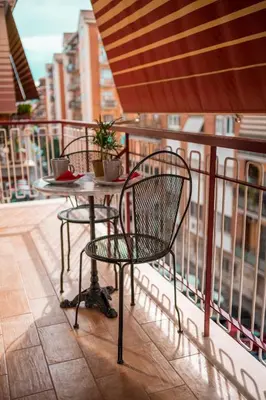 a table and chairs sitting on a balcony at La casa di Gegè Appio Caffarella in Rome