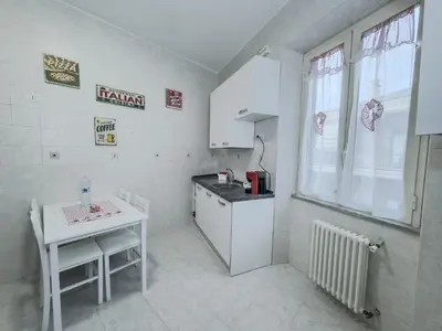 a small kitchen with a table and a counter top at Casa Noemi in Rome