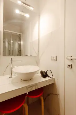 a bathroom with a white sink and a mirror at Happy Home in Rome