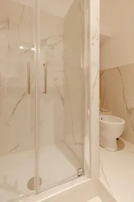 a shower with a glass door in a bathroom at Happy Home in Rome