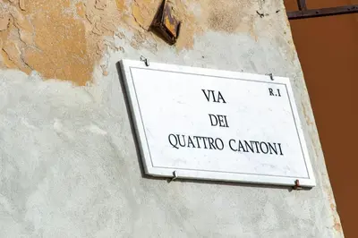a sign on the side of a wall at 4 Cantoni, cosy apartment in Monti District in Rome