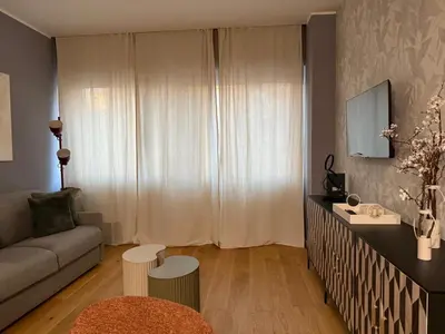 a living room with a couch and a table at Twentythree Luxury Apartment in Rome