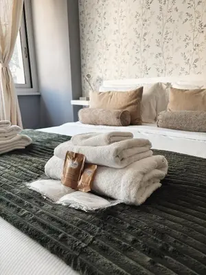 a room with two beds with towels on them at Twentythree Luxury Apartment in Rome