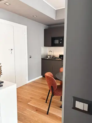 a kitchen and dining room with a table and chairs at Twentythree Luxury Apartment in Rome