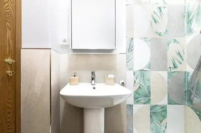 a bathroom with a white sink and a mirror at Vatican Cipro Guest House in Rome