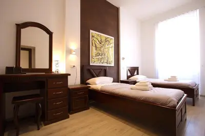 a bedroom with two beds and a mirror and a dresser at Ottaviano 2BR Holiday House in Rome
