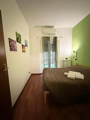 a bedroom with a bed and a wooden floor at Cute apartment next to vatican in Rome