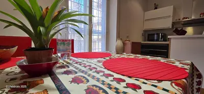 a kitchen with a table with a table cloth on it at L'Oasi di Monteverde - grazioso e collegatissimo in Rome