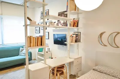 a room with a desk and a book shelf at 10 Minuti Stazione Trastevere - Atelier 19 1BDR by Hôtea in Rome