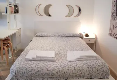 a bedroom with a bed and a table with a desk at 10 Minuti Stazione Trastevere - Atelier 19 1BDR by Hôtea in Rome