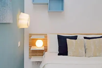 a bedroom with a bed with a lamp next to it at La corte di San Paolo by DomusDimore in Rome