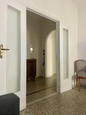 an open door into a room with a chair at Antoni House San Giovanni in Rome