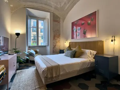 a bedroom with a large bed and a window at La Casa al Colosseo in Rome