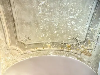 a bathroom with a damaged ceiling and a white tub at La Casa al Colosseo in Rome