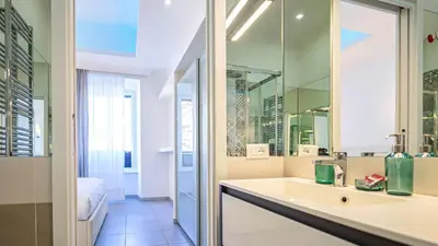 a bathroom with a sink and a mirror at EasyTopStay - Stylish Vatican Retreat in Rome