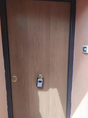 a wooden door with a sign on it at Garbatella seminterrato in Rome