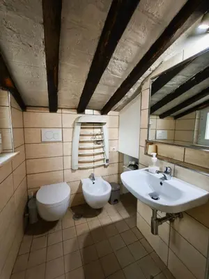 a bathroom with a toilet and a sink at Piccolo Attico in Rome