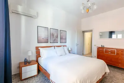 a bedroom with a large white bed and a dresser at Casa Laberio by Hili in Rome