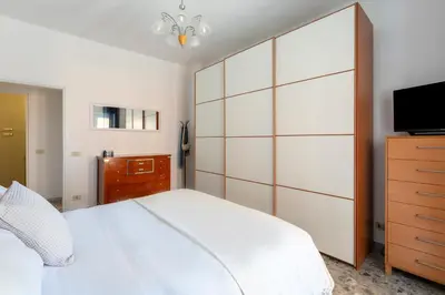 a bedroom with a large white bed and a tv at Casa Laberio by Hili in Rome
