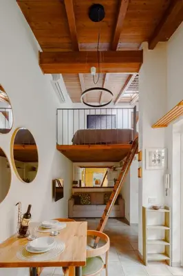 a room with a loft bed and a wooden table at Casa Piccinino in Rome
