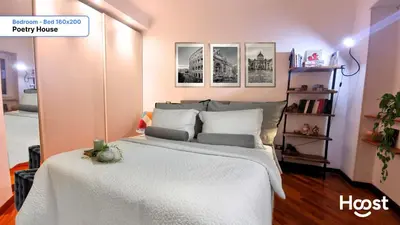 a bedroom with a large bed with white sheets at Poetry House in Rome