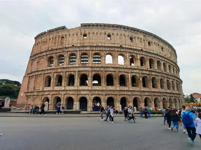 a group of people walking in front of the coliseum at Metro Battistini- D'Alessandro Holiday Home in Rome