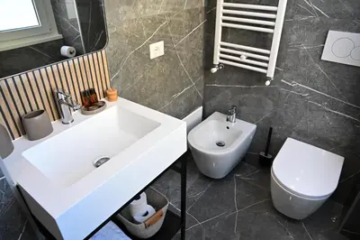 a bathroom with a white sink and a toilet at Appia Luxury Apartment in Rome