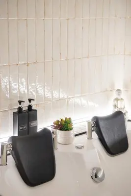 a bathroom sink with two soap dispensers on it at Ventuno Dei Luxury Suites San Giovanni in Rome