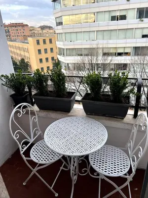 a white table and two chairs on a balcony at CAFE Portonaccio apartment in Rome