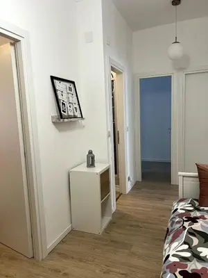 a white room with a bed and a table in it at CAFE Portonaccio apartment in Rome