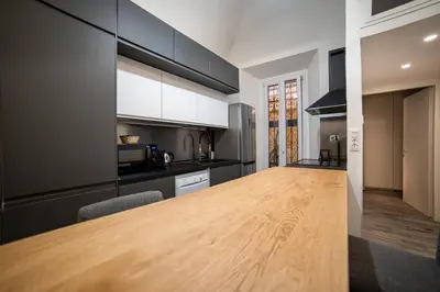 a kitchen with a wooden table in a room at Luxury suite al Vaticano in Rome