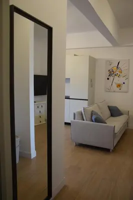 a living room with a couch and a mirror at Casa Sisto in Rome