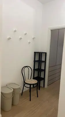 a chair and a stool in a room at Casa Sisto in Rome