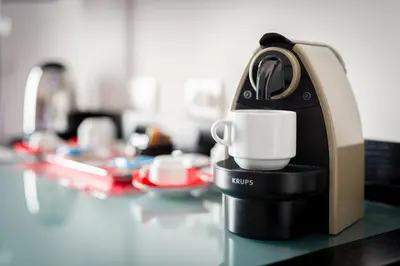 a coffee maker sitting on a counter with a cup at A Trastevere da M.E. in Rome