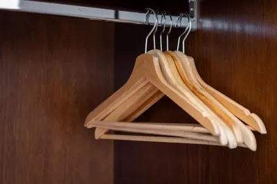a bunch of wooden utensils hanging on a door at A Trastevere da M.E. in Rome